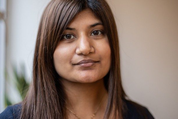 Image shows a woman facing the camera